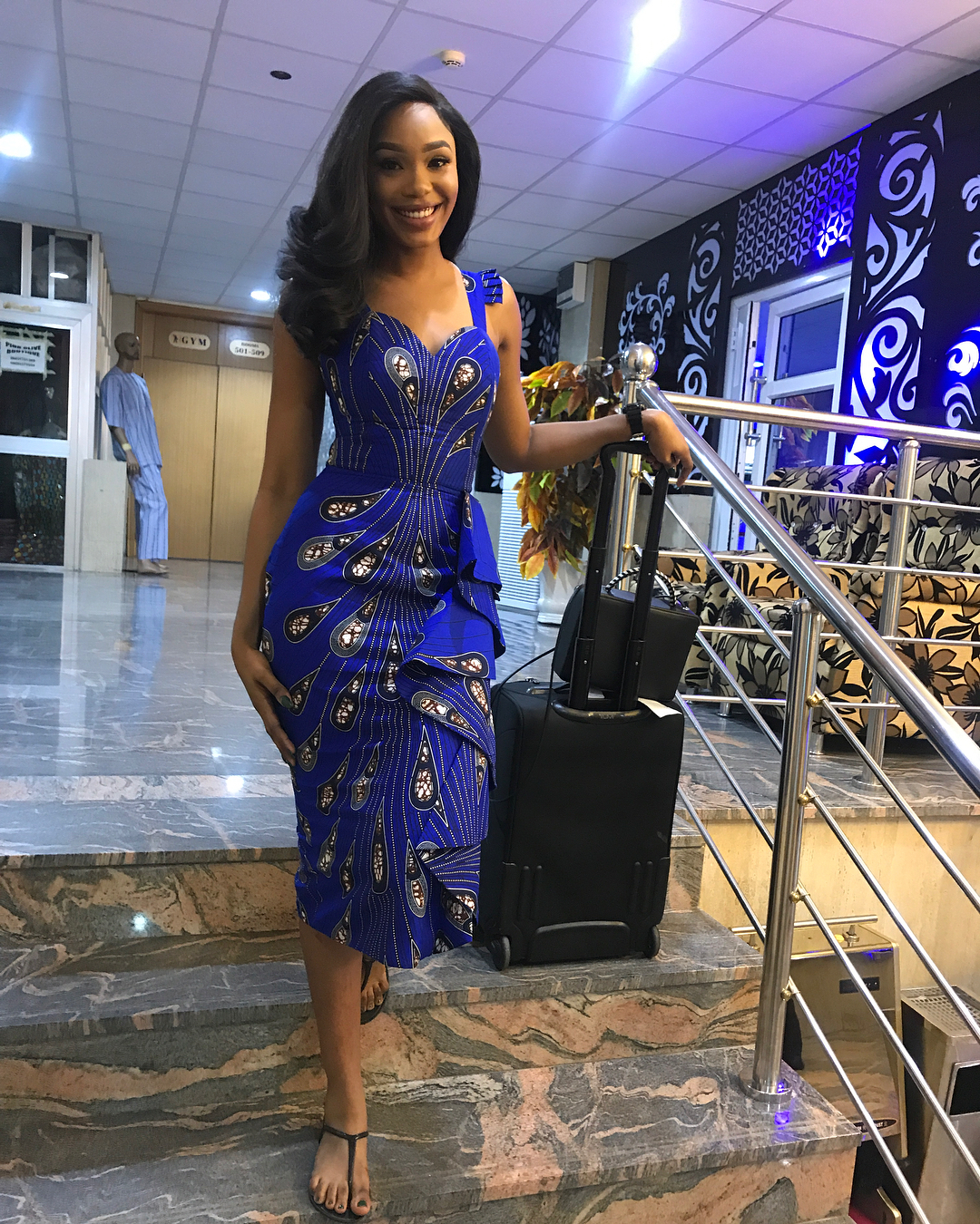 Sharon Ooja styles in a short blue gown