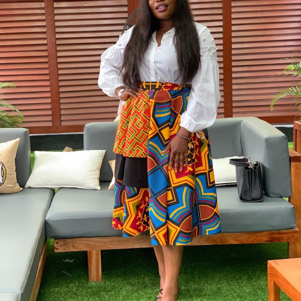 Bisola looks super in flared skirt with a white top